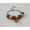 Pulseira de prata com missangas e laço cor-de-laranja